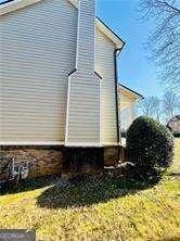 view of property exterior featuring a lawn