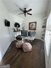 living area featuring ceiling fan and dark hardwood / wood-style floors