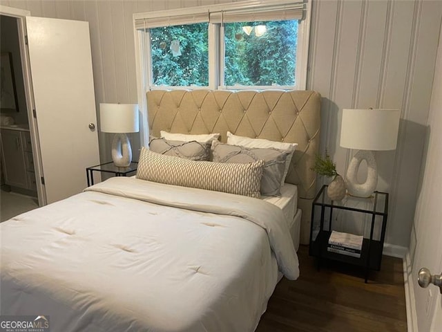 bedroom with dark hardwood / wood-style flooring