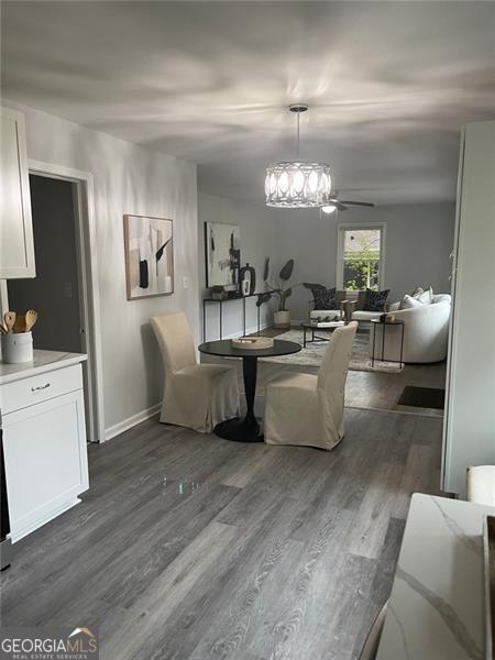 dining area featuring ceiling fan and dark hardwood / wood-style floors