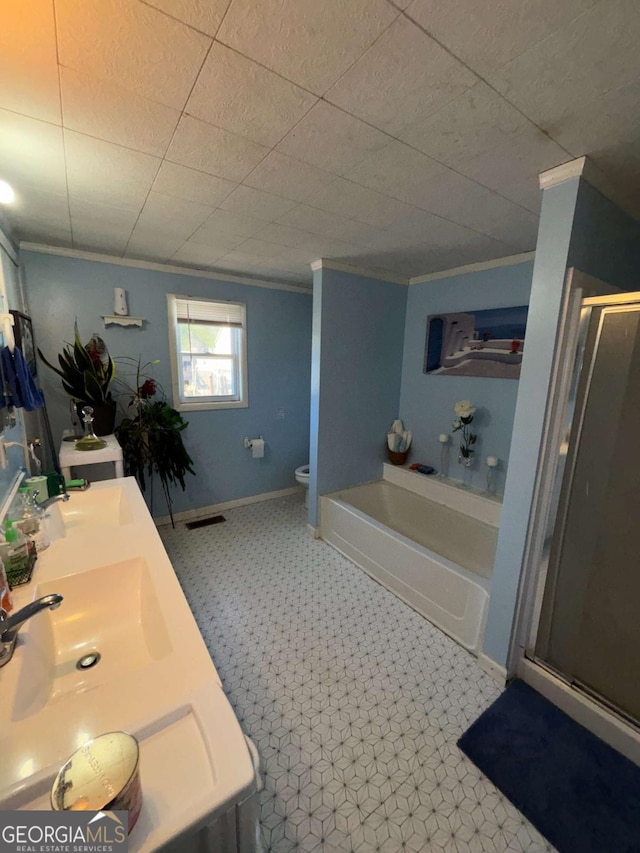 full bathroom featuring crown molding, shower with separate bathtub, vanity, and toilet