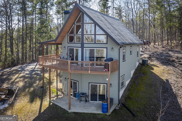 rear view of house featuring central AC and a patio