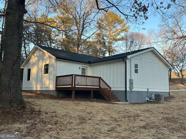 back of property with central AC and a deck