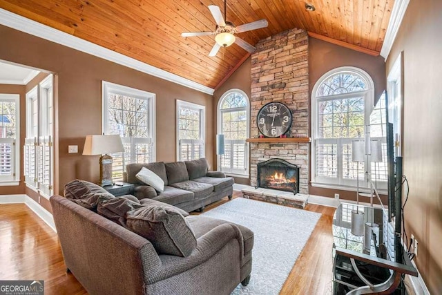 living room featuring crown molding, a healthy amount of sunlight, and wooden ceiling