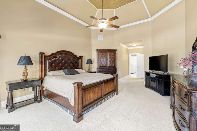 bedroom with crown molding, light colored carpet, ceiling fan, and a towering ceiling