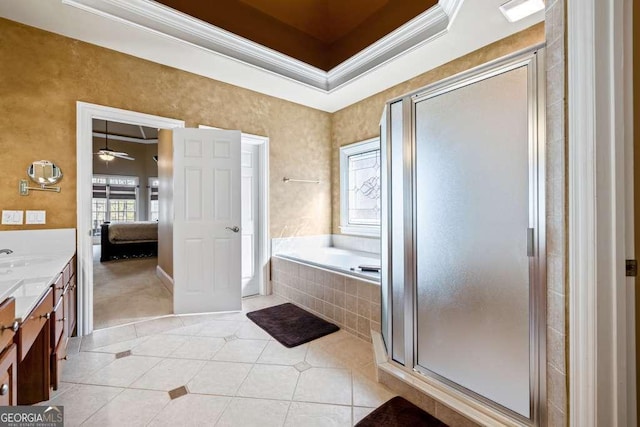 bathroom featuring independent shower and bath, vanity, a raised ceiling, crown molding, and tile patterned floors