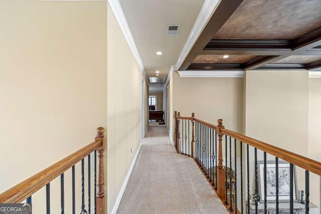 hallway with coffered ceiling, ornamental molding, light colored carpet, and beamed ceiling