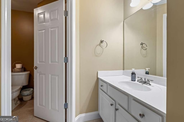 bathroom featuring vanity, toilet, and tile patterned flooring