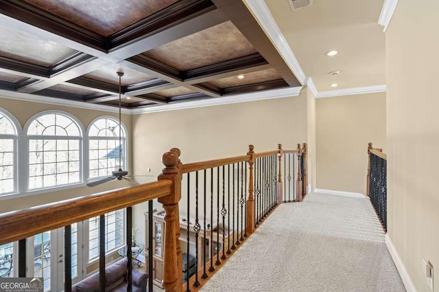 hall with beamed ceiling, coffered ceiling, and carpet flooring