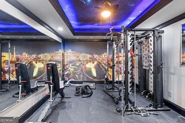 workout area with a tray ceiling