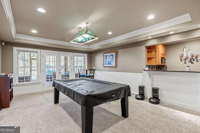 game room featuring french doors, crown molding, light carpet, and a tray ceiling