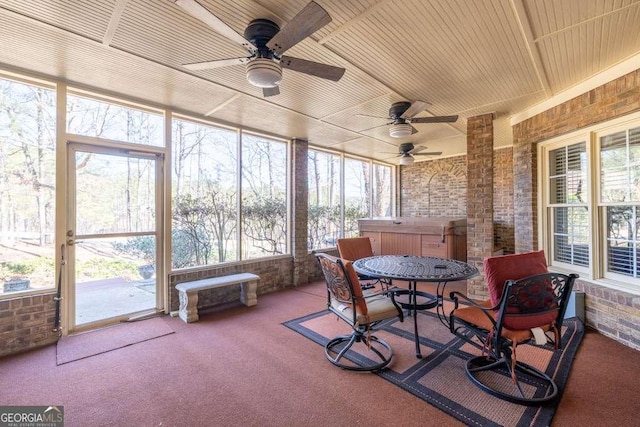 sunroom with plenty of natural light, wooden ceiling, and ceiling fan