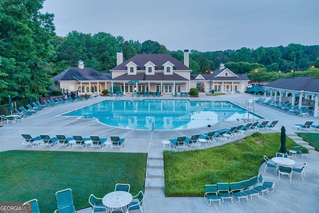 view of swimming pool featuring a patio and a yard