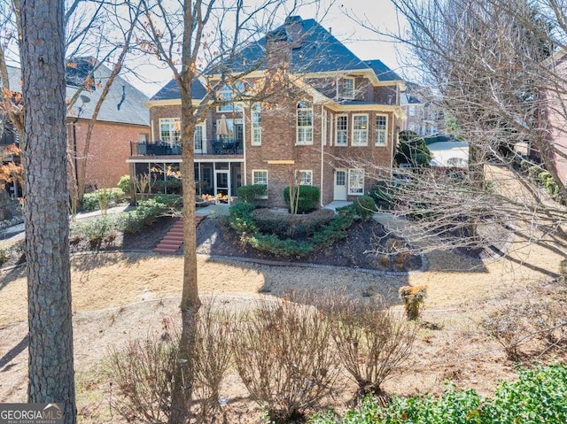 rear view of property with a balcony