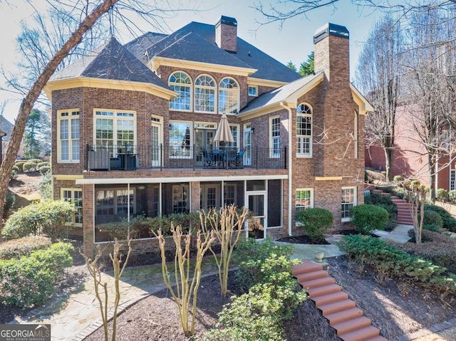 rear view of property featuring a balcony