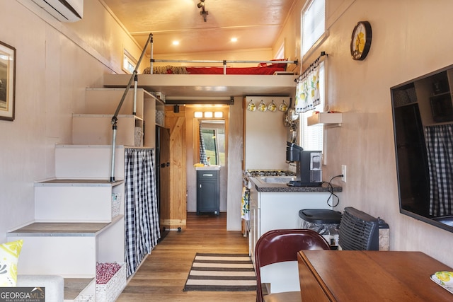 kitchen with light hardwood / wood-style flooring and a wall mounted AC