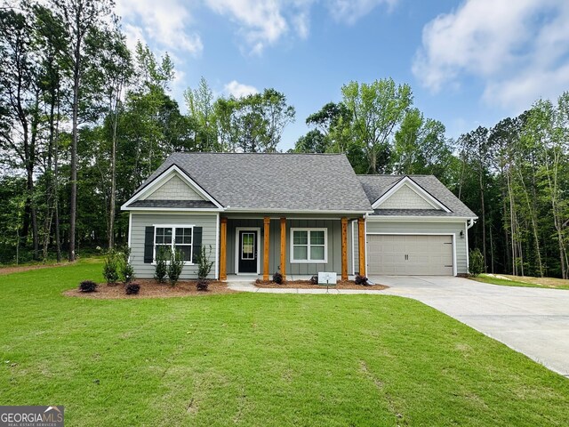 25 Patterson Dr, Franklin, GA 30217 - view of front of house featuring a porch, concrete driveway, an attached garage, a front yard, and roof with shingles