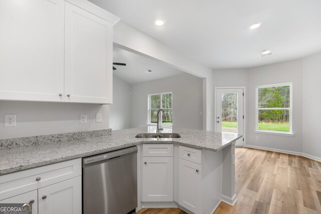 25 Patterson Dr, Franklin, GA 30217 - kitchen with stainless steel dishwasher, a sink, a peninsula, white cabinets, and light wood-style flooring
