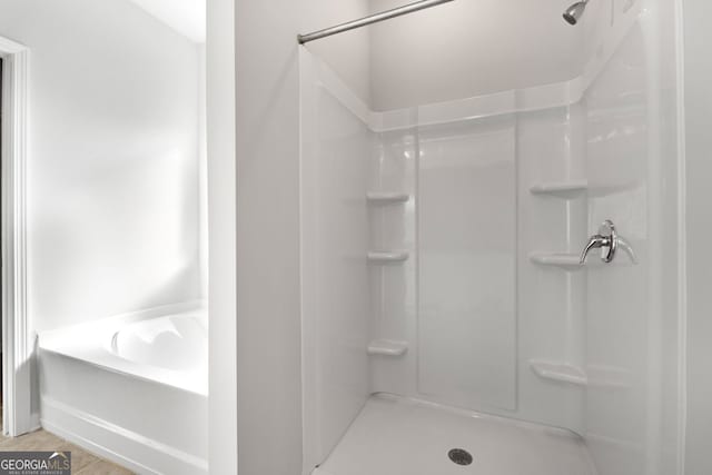 bathroom with tile patterned flooring and a shower