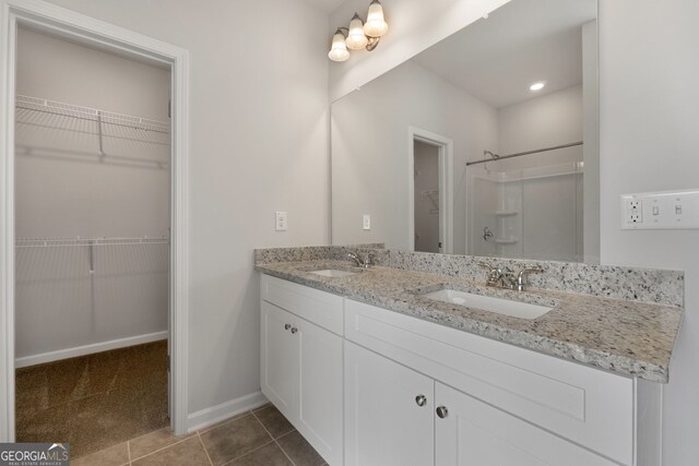 25 Patterson Dr, Franklin, GA 30217 - full bath with tile patterned flooring, double vanity, a shower, a spacious closet, and baseboards