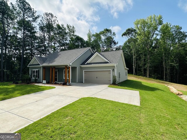 25 Patterson Dr, Franklin, GA 30217 - ranch-style house featuring an attached garage, a front lawn, driveway, and covered porch