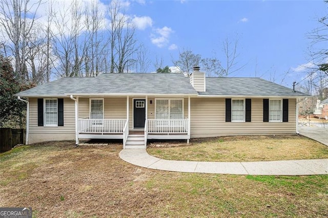 single story home with covered porch and a front lawn