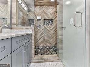 bathroom featuring vanity and an enclosed shower