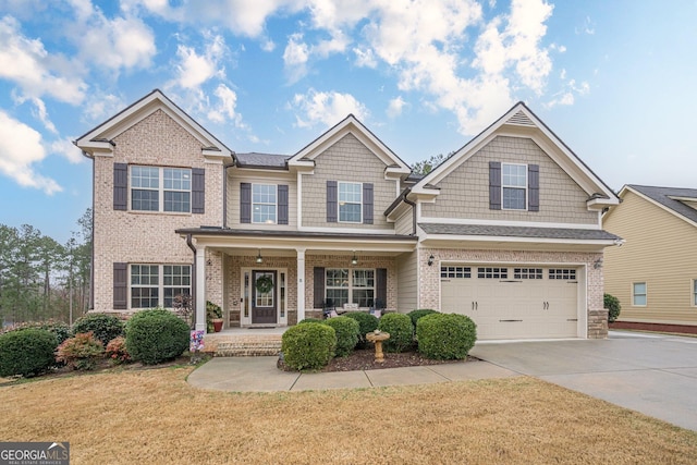 view of front of house with a garage, covered porch, and a front lawn