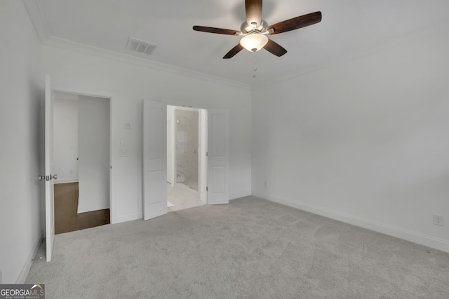 unfurnished bedroom with ornamental molding, light carpet, ceiling fan, and ensuite bath