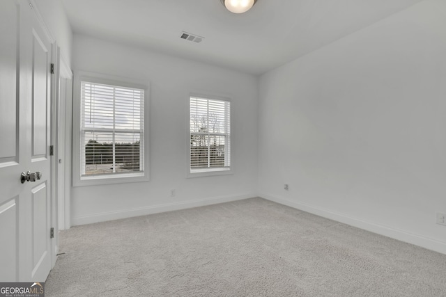 unfurnished room with light carpet