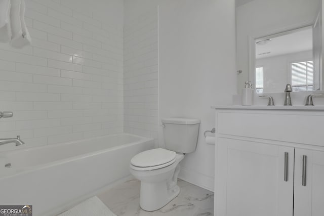 full bathroom featuring vanity, toilet, and tiled shower / bath combo