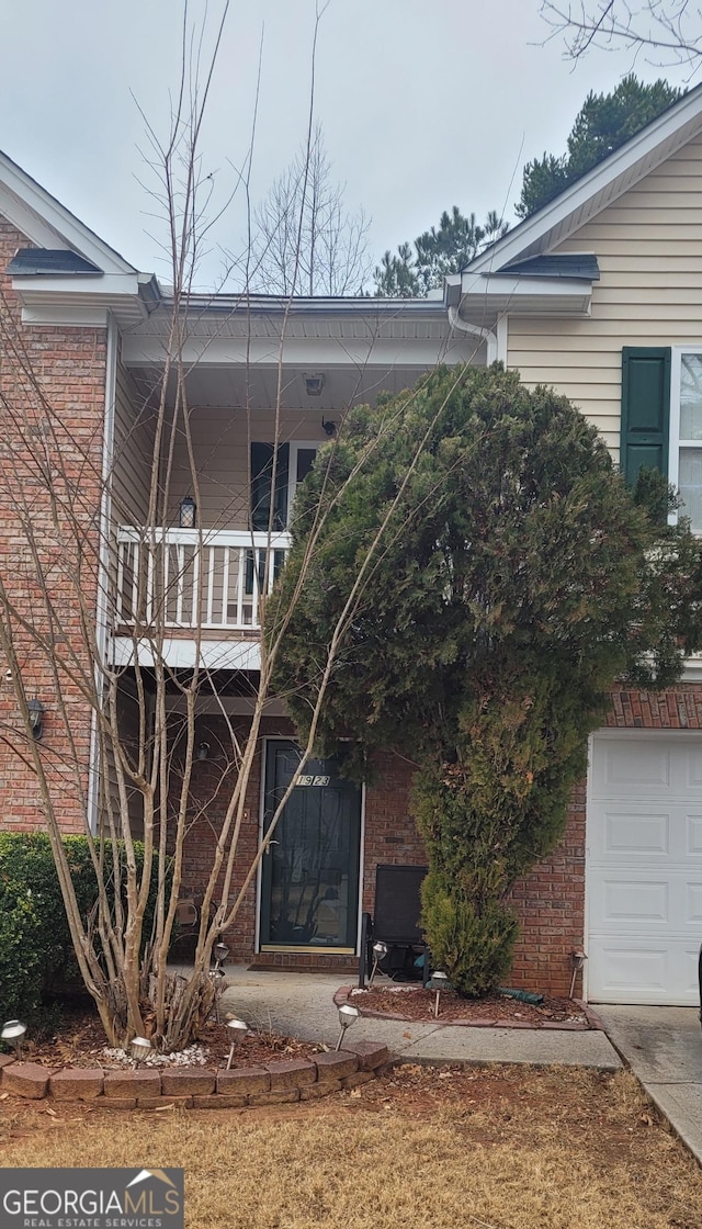 back of house with a balcony and a garage