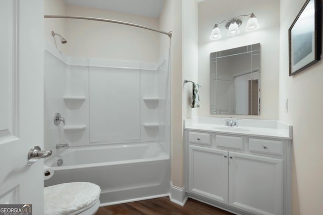 full bathroom featuring hardwood / wood-style flooring, vanity, bathtub / shower combination, and toilet