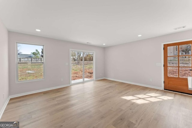 unfurnished room with light hardwood / wood-style floors