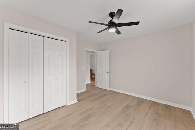 unfurnished bedroom featuring light hardwood / wood-style flooring, a closet, and ceiling fan