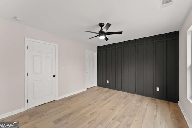 unfurnished bedroom with ceiling fan and light hardwood / wood-style floors