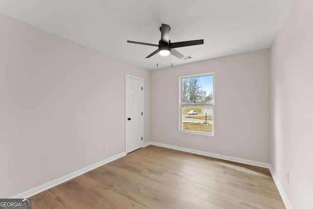 spare room featuring light hardwood / wood-style flooring and ceiling fan