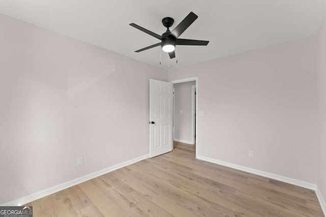 empty room with ceiling fan and light wood-type flooring