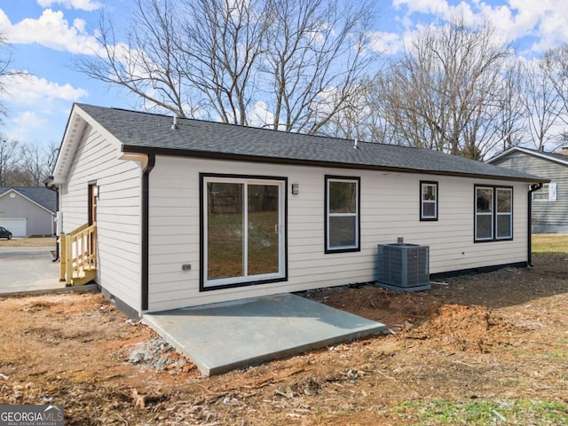 rear view of property featuring central AC unit and a patio area