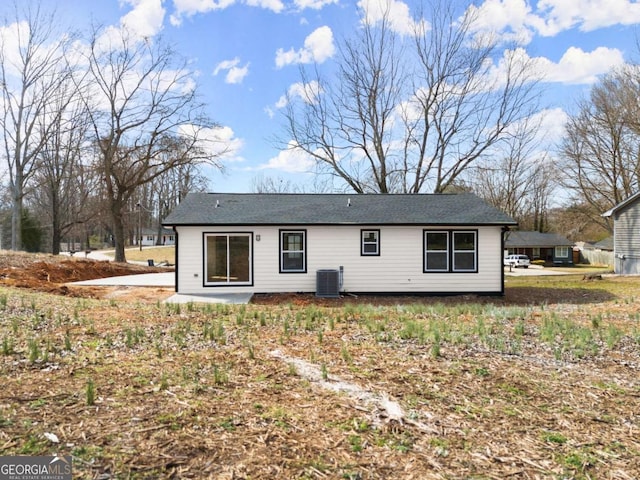 rear view of house featuring cooling unit and a patio area