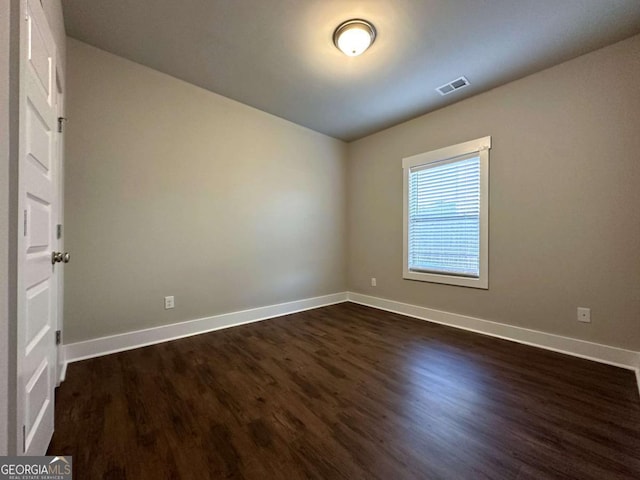 empty room with dark wood-type flooring