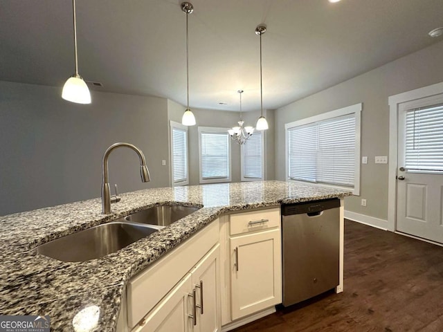 kitchen with white cabinetry, sink, hanging light fixtures, stainless steel dishwasher, and light stone counters