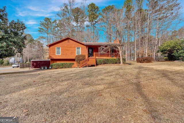 single story home with a porch, a jacuzzi, and a front lawn