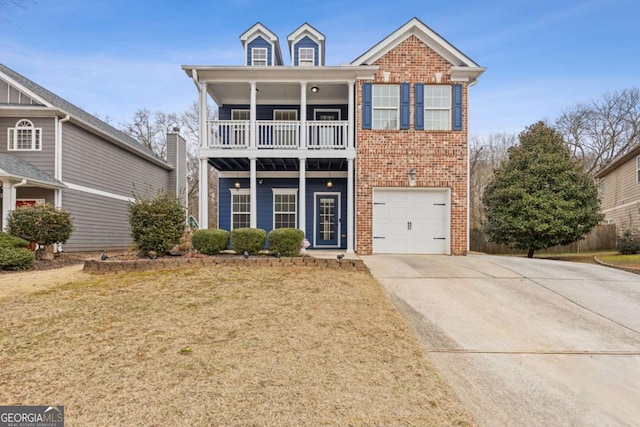 view of front of property with a garage, a front yard, and a balcony