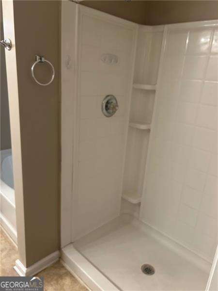 bathroom with tiled shower