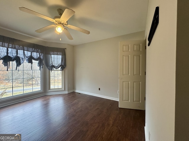 spare room with ceiling fan and dark hardwood / wood-style floors