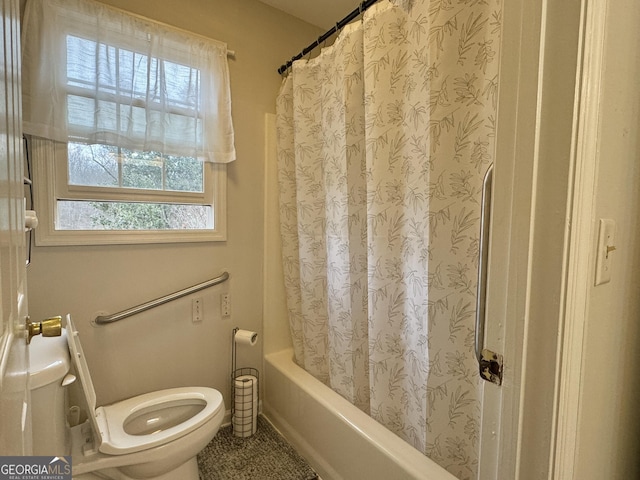 bathroom featuring shower / bathtub combination with curtain and toilet