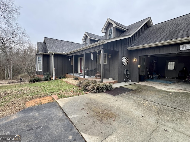 view of property exterior with a garage and covered porch