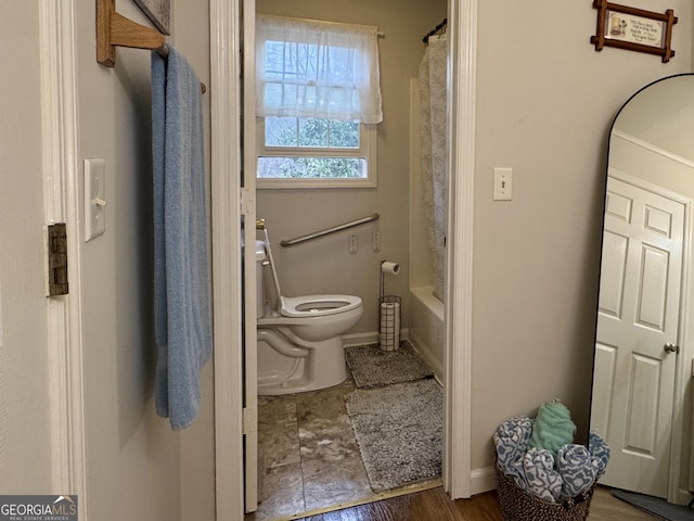 bathroom featuring shower / tub combo with curtain and toilet