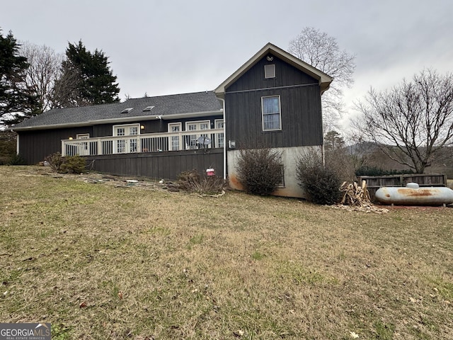 back of house with a lawn